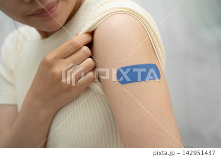 HPV, Human papillomavirus, Asian young woman receiving vaccine with blue bandage. 142951437