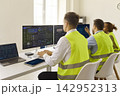 Back view of logistics dispatchers at dashboards, monitoring transport analytics 142952313