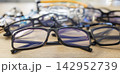 Assorted prescription eyeglasses and stylish frames arranged for customer choice 142952739