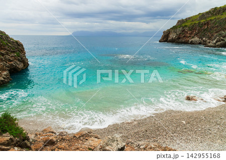 Turquoise water in a secluded Mediterranean lagoon framed by rugged rocky coastal cliffs Turquoise water in a secluded Mediterranean lagoon framed by rugged rocky coastal cliffs 142955168