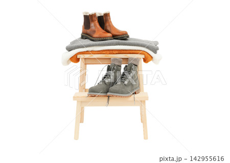 Fall clothing. Casual boots and warm sweaters arranged together on a wooden rack, PNG Fall clothing. Casual boots and warm sweaters arranged together on a wooden rack, PNG 142955616
