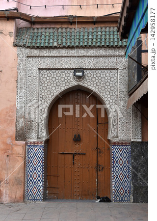 Traditional Moroccan wooden door in Marrakech Medina 142958177
