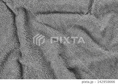 Close-up of gray terry cloth towel fabric with soft folds and looped pile texture textile background Close-up of gray terry cloth towel fabric with soft folds and looped pile texture textile background 142958666