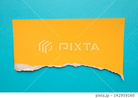 piece of yellow paper tear isolated on blue background piece of yellow paper tear isolated on blue background 142959160