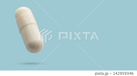 White medicine pill capsule float on blue background White medicine pill capsule float on blue background 142959346