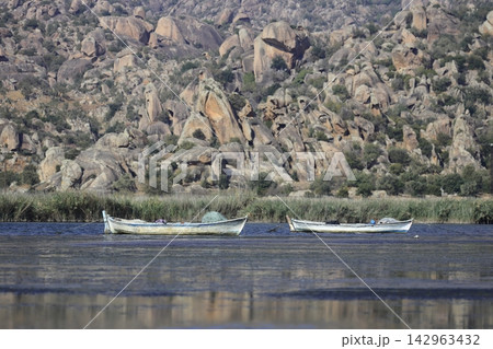 Fishing boats moored along the shore of Lake Bafa in Turkey. Selective Focus. Fishing boats moored along the shore of Lake Bafa in Turkey. Selective Focus. 142963432