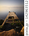 old, rusty abandoned and dismantled pier. sky space is empty. suitable for writing. Seaside town of Turgutreis and spectacular sunshine. Long Exposure shoot. tranquility scene. 142963512