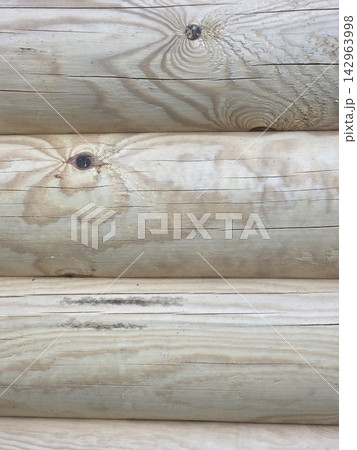 Smooth wooden logs stacked wall texture background 142963998