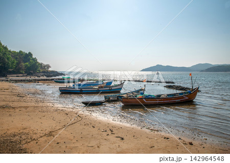 Fishermen - a man and a woman, mother and son, unravel the polluted fishing net and smile, prepare the net for the next fishing Fishermen - a man and a woman, mother and son, unravel the polluted fishing net and smile, prepare the net for the next fishing 142964548