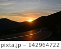 Winding Mountain Road at Sunset with Sunstar 142964722