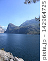 Scenic Mountain Lake with Granite Cliffs and Blue Sky 142964725