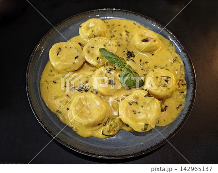 Sorrentinos in Creamy Orange Sauce with Basil 142965137