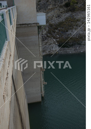 View from high angle of concrete wall and intake tower at Amadorio Dam above turquoise water View from high angle of concrete wall and intake tower at Amadorio Dam above turquoise water 142965161