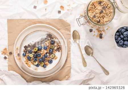 Healthy Yogurt Breakfast Bowl with Granola and Berries Healthy Yogurt Breakfast Bowl with Granola and Berries 142965326