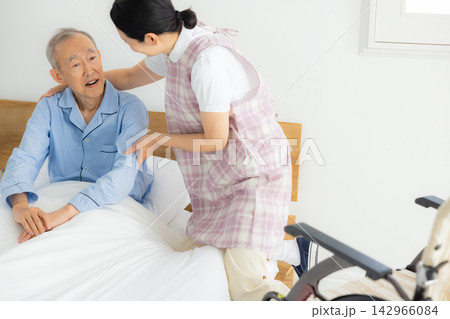 介護施設で暮らすシニア男性と介護士 介護施設で暮らすシニア男性と介護士 142966084