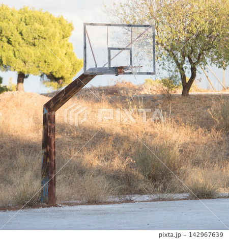 Outdoor Basketball Hoop on Weathered Rural Court Outdoor Basketball Hoop on Weathered Rural Court 142967639