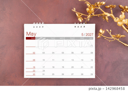 Desk calendar for May 2027 year with gold cherry blossoms branch. 142968458