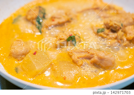 Creamy yellow curry with chicken and potato served in bowl Creamy yellow curry with chicken and potato served in bowl 142971703