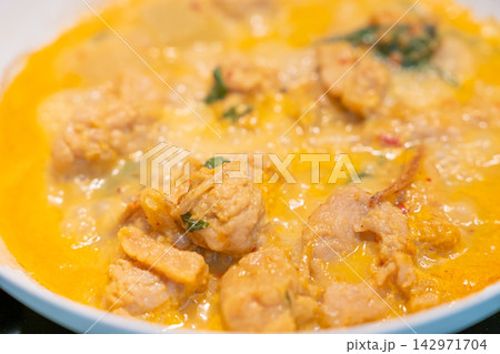 Creamy chicken curry with herb garnish creates warm appetizing meal Creamy chicken curry with herb garnish creates warm appetizing meal 142971704