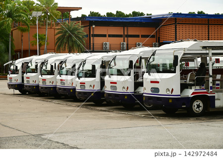 Electric park shuttles car or sightseeing car are lined up in the parking area. Electric park shuttles car or sightseeing car are lined up in the parking area. 142972484