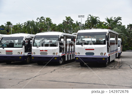 Electric park shuttles car or sightseeing car are lined up in the parking area. Electric park shuttles car or sightseeing car are lined up in the parking area. 142972676