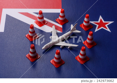 A mock up of airplane surrounded by no fly signs on a New Zealand flag A mock up of airplane surrounded by no fly signs on a New Zealand flag 142973662