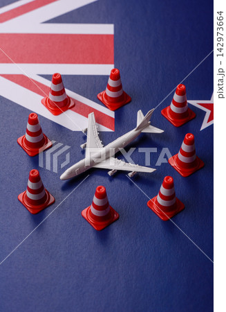 A mock up of airplane surrounded by no fly signs on a New Zealand flag A mock up of airplane surrounded by no fly signs on a New Zealand flag 142973664