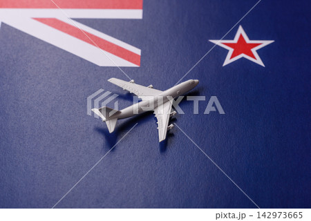 An airplane on the New Zealand flag as a conceptual backdrop for flights and travel An airplane on the New Zealand flag as a conceptual backdrop for flights and travel 142973665