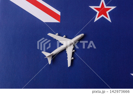 An airplane on the New Zealand flag as a conceptual backdrop for flights and travel An airplane on the New Zealand flag as a conceptual backdrop for flights and travel 142973666