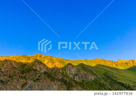 Golden Mountain Slopes Under Clear Blue Sky Golden Mountain Slopes Under Clear Blue Sky 142977816