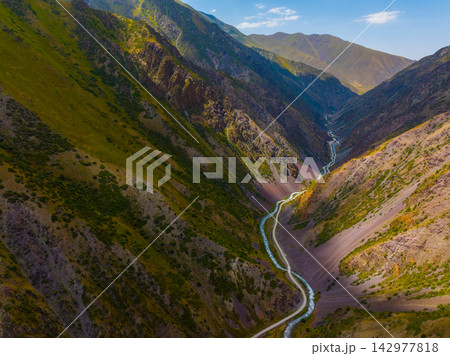 Aerial View of Mountain Valley with River and Road 142977818