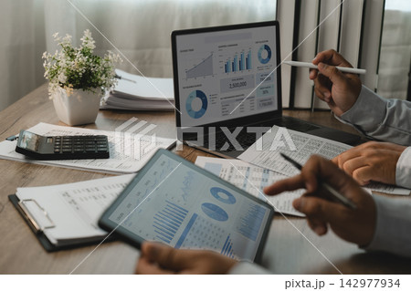 Business team reviewing accounting financial reports and tablet dashboards, reviewing business reports for performance analysis and financial reporting. Business team reviewing accounting financial reports and tablet dashboards, reviewing business reports for performance analysis and financial reporting. 142977934