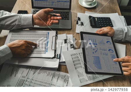 Business team reviewing accounting financial reports, calculator and tablet dashboard for business data analysis, financial review and reporting workflow. Business team reviewing accounting financial reports, calculator and tablet dashboard for business data analysis, financial review and reporting workflow. 142977938