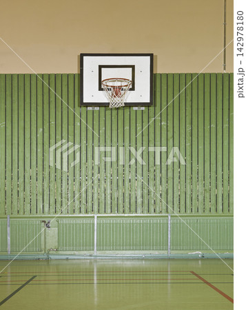 Basketball Hoop in Empty Indoor Gym with Green Wall Basketball Hoop in Empty Indoor Gym with Green Wall 142978180