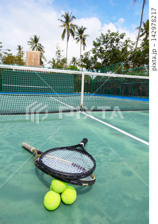 Tennis Rackets and Balls on Tropical Outdoor Court Tennis Rackets and Balls on Tropical Outdoor Court 142978217