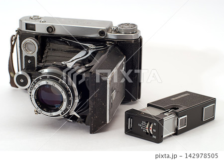 Vintage Folding Film Camera and Flash on White Background 142978505