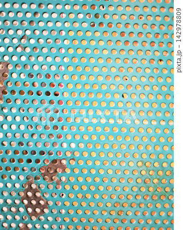 Detailed view of turquoise painted metal mesh with industrial circular perforations and weathered rust patches perfect for architectural or design backgrounds. Detailed view of turquoise painted metal mesh with industrial circular perforations and weathered rust patches perfect for architectural or design backgrounds. 142978809