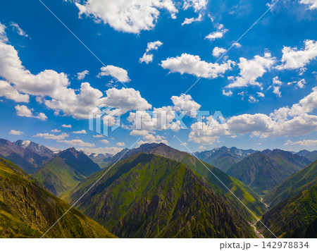 Aerial view of mountain range in Kyrgyzstan under blue sky 142978834