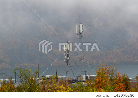 Telecommunication towers with antennas in misty mountain region Telecommunication towers with antennas in misty mountain region 142979280