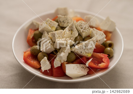 Greek style salad with tomatoes, bell pepper, olives and feta cheese Greek style salad with tomatoes, bell pepper, olives and feta cheese 142982089