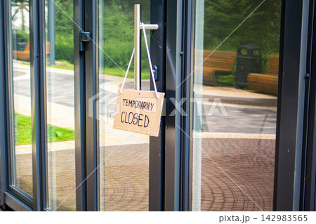 TEMPORARILY CLOSED sign on private shop window. Small local retail business closes because of financial and economic crisis. Entrepreneurs faces market changes TEMPORARILY CLOSED sign on private shop window. Small local retail business closes because of financial and economic crisis. Entrepreneurs faces market changes 142983565
