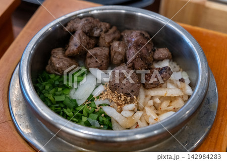 Medium rare beef rice in a steamed pot. Korean food Medium rare beef rice in a steamed pot. Korean food 142984283