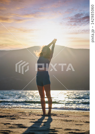 Urdhva Hastasana Upward Salute Yoga on Beach at Sunrise Urdhva Hastasana Upward Salute Yoga on Beach at Sunrise 142985060
