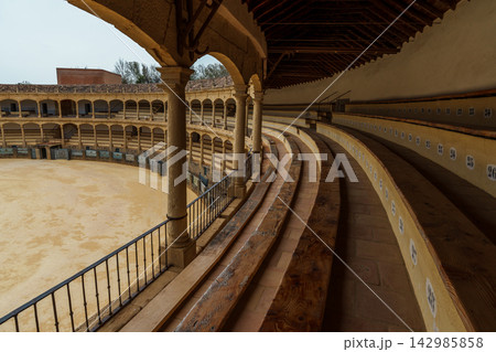 Curved wooden seating rows inside Ronda's historic bullring Curved wooden seating rows inside Ronda's historic bullring 142985858