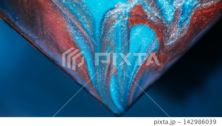Shimmer paint. Sparkling fluid. Defocused blue orange purple color triangle marble mix texture spilling on abstract art background. 142986039