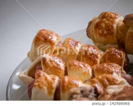 Freshly baked savory pastries with filling on a plate 142986068