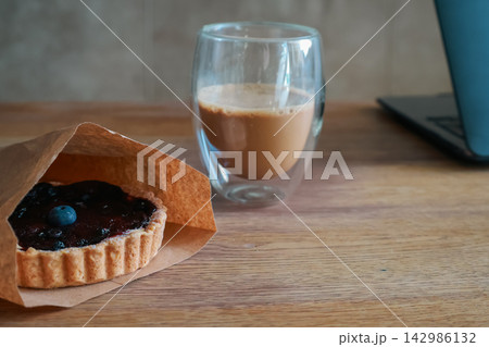 Blueberry muffin and cup of coffee with milk. Blueberry fruit on tart and coffee cup. Sweet breakfast. Cappuccino and dessert. Tart with berry jam and hot coffee. Homemade pastry. Blueberry muffin and cup of coffee with milk. Blueberry fruit on tart and coffee cup. Sweet breakfast. Cappuccino and dessert. Tart with berry jam and hot coffee. Homemade pastry. 142986132