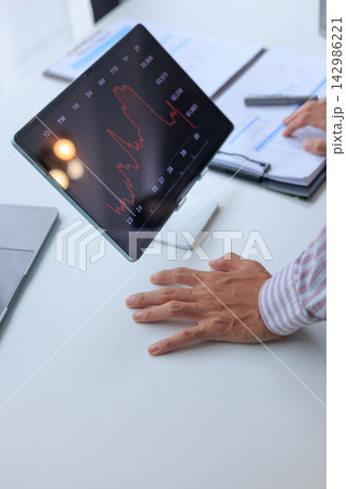 Man at Office Desk Monitoring Bearish Financial Chart Showing Significant Market Losses On Desktop Tablet Screen. 142986221