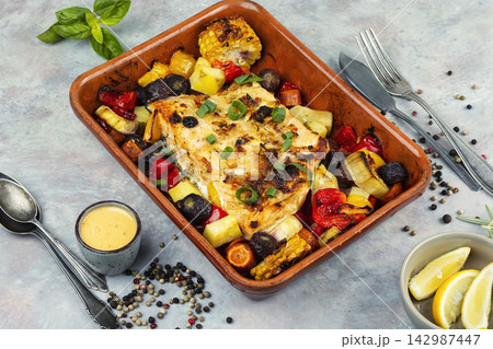 Baked salmon and vegetables in a baking tray. Baked salmon and vegetables in a baking tray. 142987447
