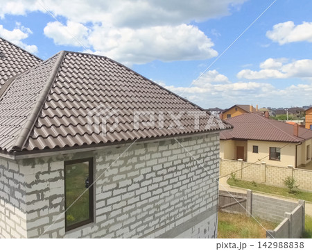 Corrugated metal roof and metal roofing. Modern roof made of met 142988838